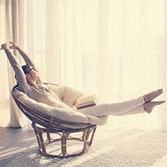 Leanrs your schedule - Woman sitting on singular chair enjoying the warmth of heat