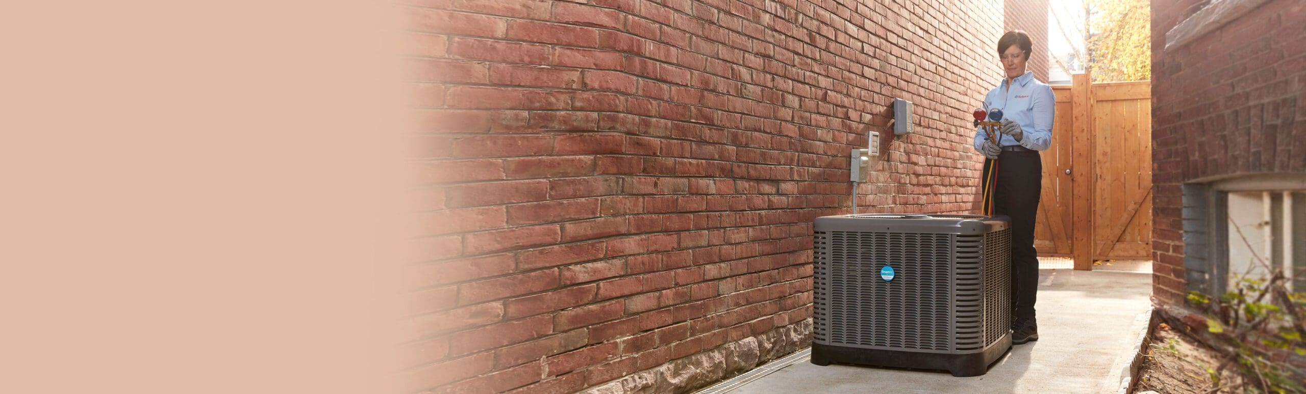 Reliance home comfort technician inspecting air conditioner